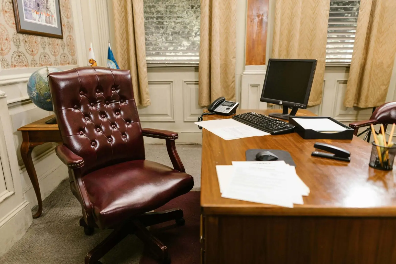 We clean private offices and stand alone offices. Image of office desk with chair and computer setup.