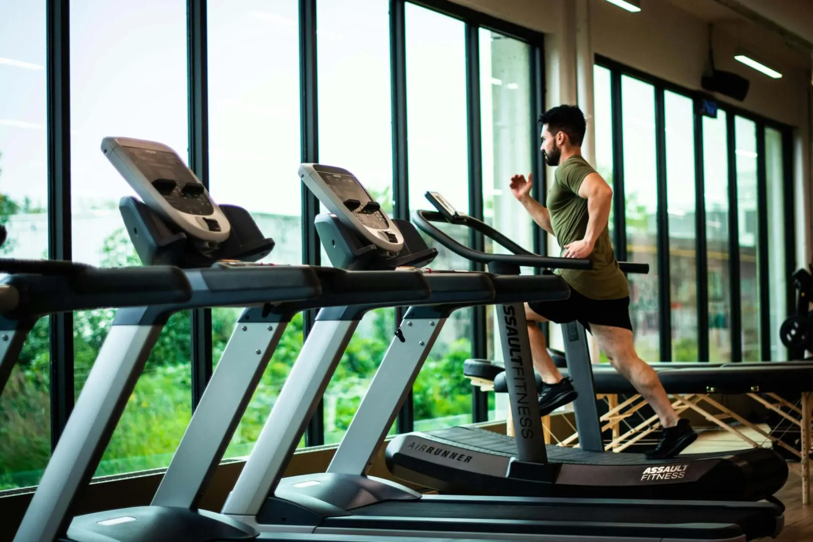 We clean & disinfect gyms and fitness centers. An image of a ,an running on treadmill in gym.