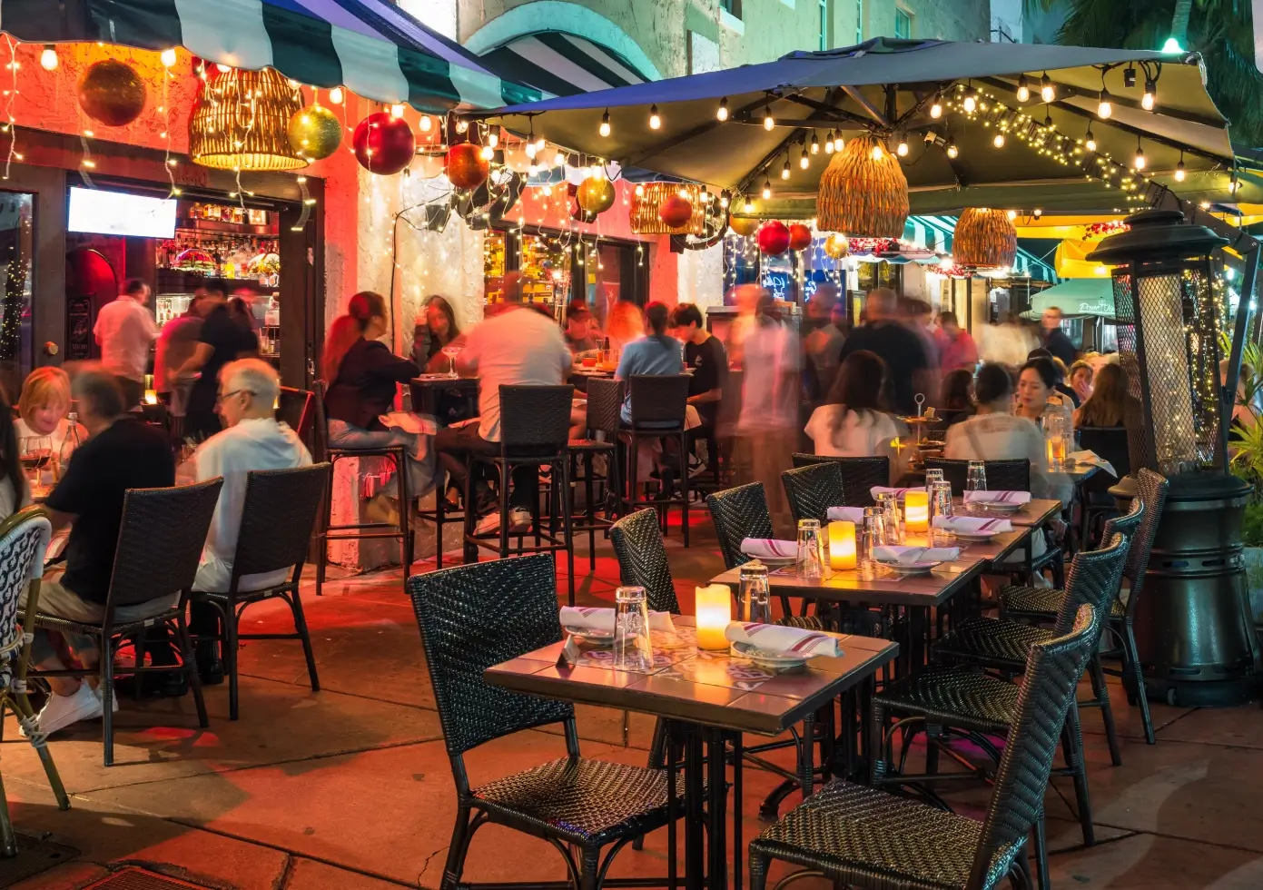 We offer cleaning services to commercial kitchens & restaurants. Image of outdoor restaurant scene with festive decorations.